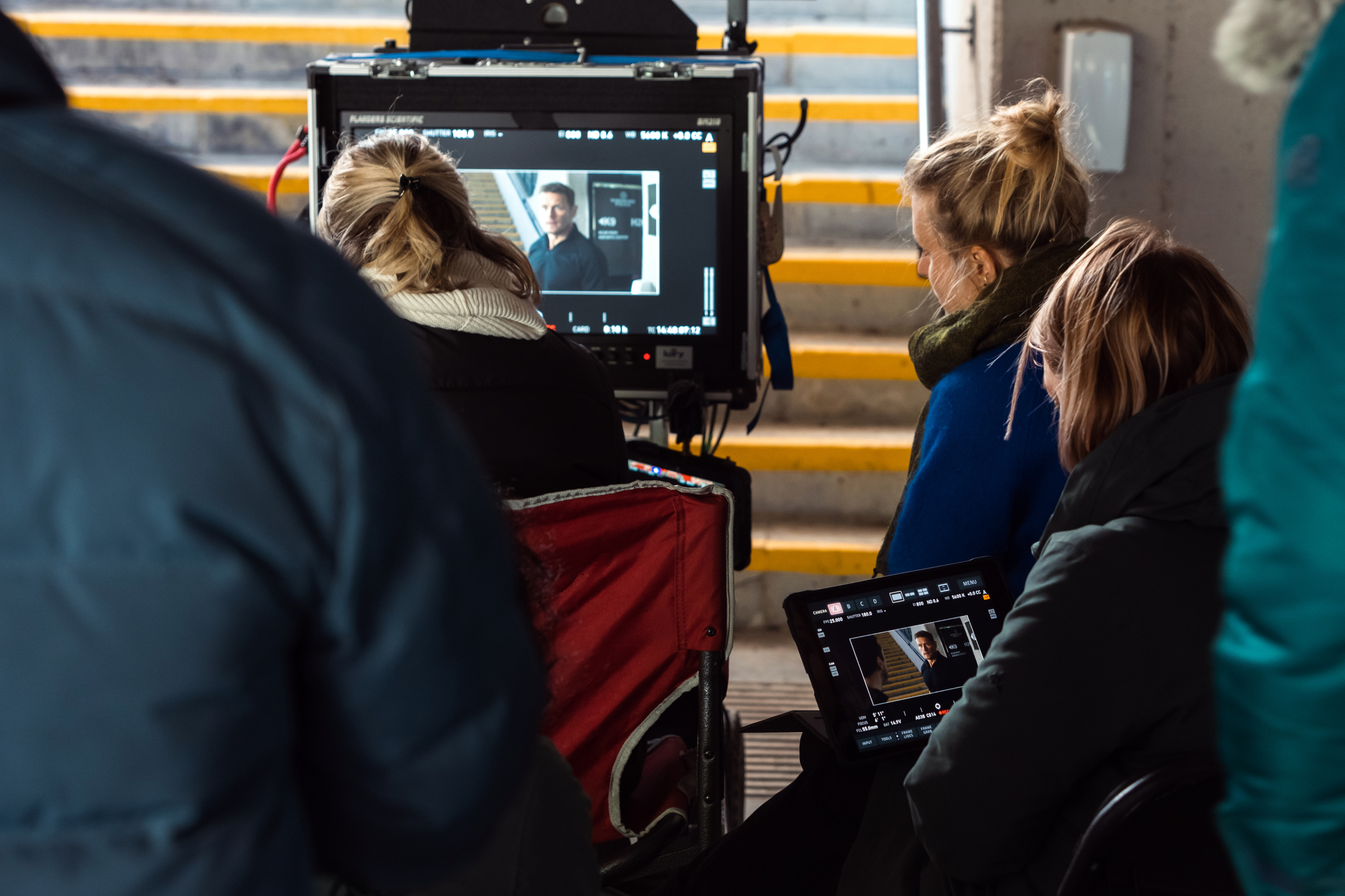 Behind-the-scenes film crew setting up equipment